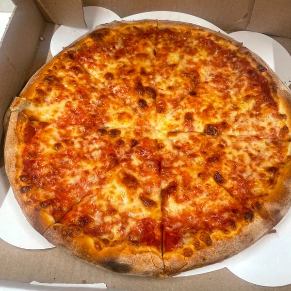 A whole cheese pizza from Johnny's Pockets, with a golden crust and melted cheese, in a delivery box.