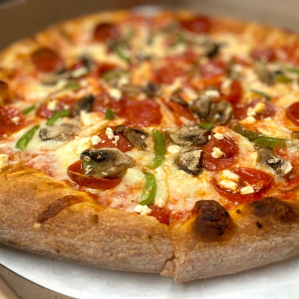 Johnny's Pockets pizza with pepperoni, mushrooms, green peppers, and feta cheese.